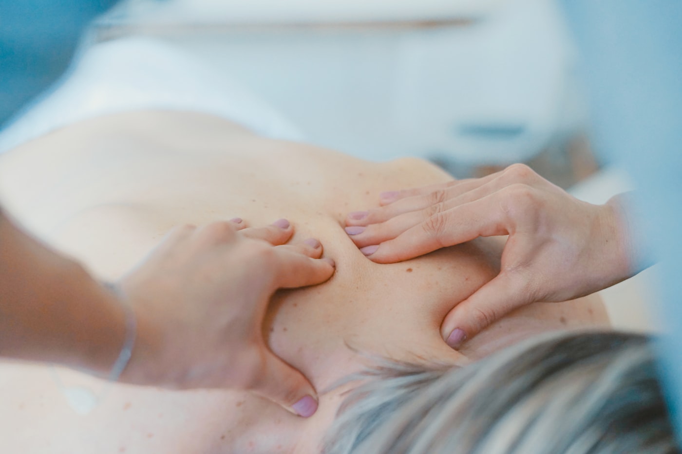 A therapist massaging a patient's lower back
