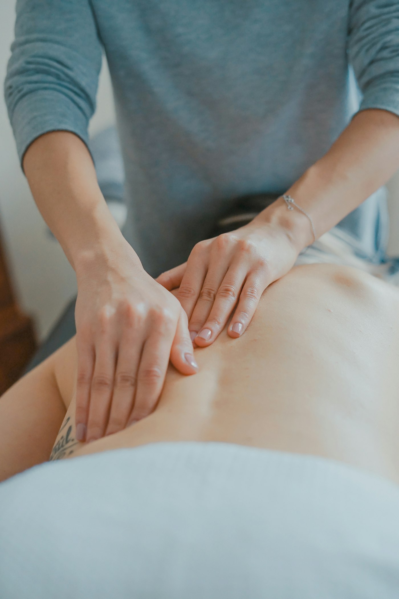 A therapist massaging a patient's shoulder and neck area